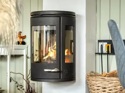 a fireplace on the wall with a fire in it at Apartment Enwald - 700m from the sea by Interhome in Pandrup