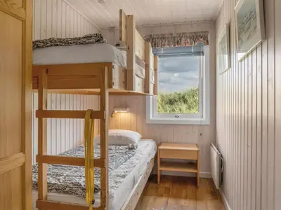 a small bedroom with bunk beds and a window at Holiday Home Myrna - 250m from the sea by Interhome in Saltum