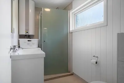 a bathroom with a toilet and a sink and a shower at 1357-Snedsted-Grahavrevej-1 in Snedsted
