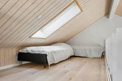 a attic bedroom with two beds and a skylight at JB367-Brovst-Kronvildtvej-102 in Brovst