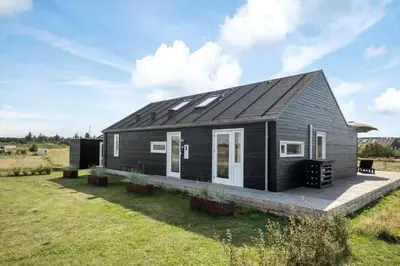 a black tiny house with solar panels on it at JB367-Brovst-Kronvildtvej-102 in Brovst