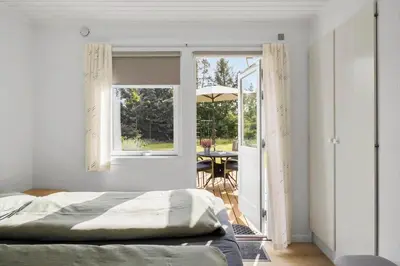 a bedroom with a bed and a view of a patio at BL1123-Saltum-Jydske-Rev-5 in Saltum