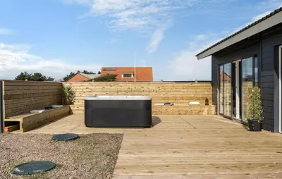 a backyard with a wooden deck with a stove at Awesome Home In Harboøre With Sauna in Harboør