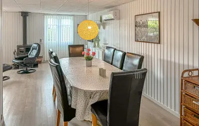 a dining room with a table and chairs at Awesome Home In Farsø With Sauna in Farsø