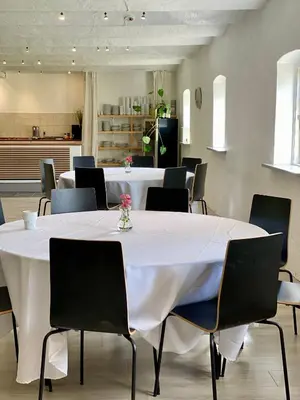 a conference room with a white table and chairs at Staarup Hovedgaard in Højslev