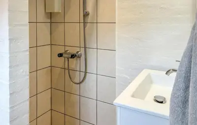 a bathroom with a shower with a sink at Ocean Front Home In Spøttrup With Sauna in Spottrup