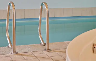 a swimming pool with metal faucets next to a sink at Ocean Front Home In Spøttrup With Sauna in Spottrup