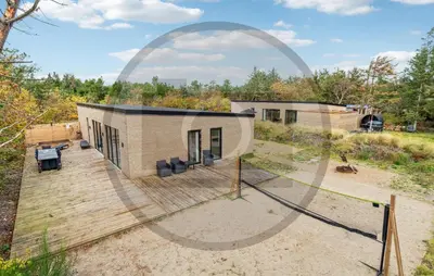 a small house in the middle of a field at 4 Bedroom Awesome Home In Thyholm in Thyholm