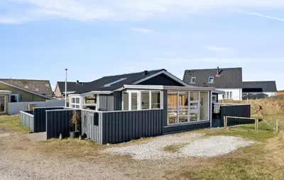 a house with a black facade on the beach at Gorgeous Home In Thisted With House A Panoramic View in Thisted