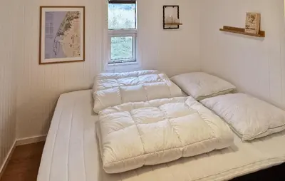 two beds sitting in a room with a window at Gorgeous Home In Thisted With House A Panoramic View in Thisted