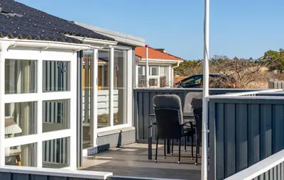 a deck with chairs and a table on a house at Gorgeous Home In Thisted With House A Panoramic View in Thisted