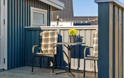 a table on a balcony with two chairs and a counter at Gorgeous Home In Thisted With House A Panoramic View in Thisted