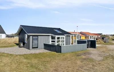 a small house with a black roof at Gorgeous Home In Thisted With House A Panoramic View in Thisted