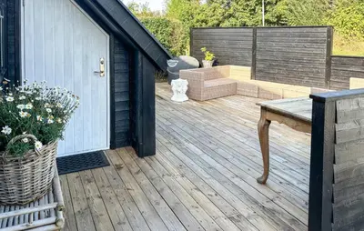 a wooden deck with a bench on top of it at Gorgeous Home In Farsø With Wifi in Farsø