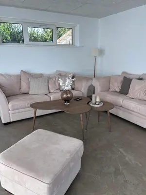 a living room with a couch and a coffee table at Udsigtsvilla Tambohus in Thyholm