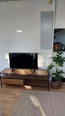 a living room with a flat screen tv on a table at Antonia s quality apartment 1 in Viborg