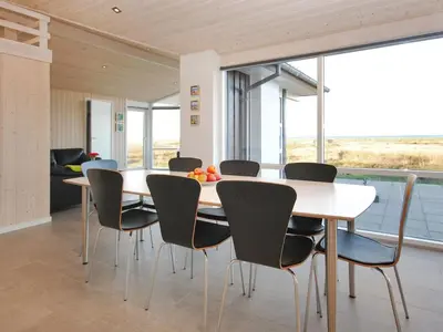 a dining room with a table and chairs at Holiday Home Arisa - 100m to the fjord by Interhome in Løgstør
