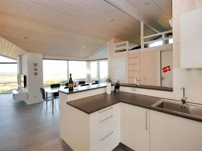 a kitchen with white cabinets and a counter top at Holiday Home Arisa - 100m to the fjord by Interhome in Løgstør