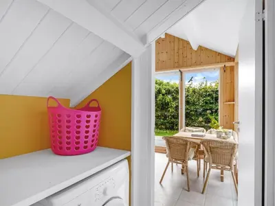 a laundry room with a pink basket on a counter at Holiday Home Elea - 450m to the fjord by Interhome in Vemb
