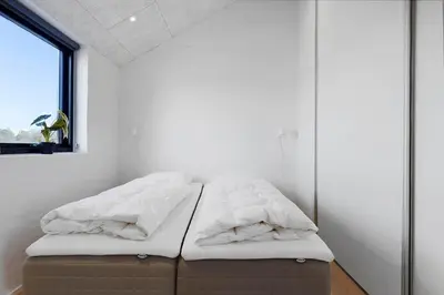 a bed in a room with a window at LK2159-Lokken-Kringelbaekvej-27 in Løkken