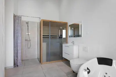 a bathroom with a shower and a toilet and a sink at LK2159-Lokken-Kringelbaekvej-27 in Løkken