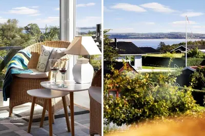 a porch with a table and a view of the water at LF14058-Roslev-Eskovvej-58 in Roslev