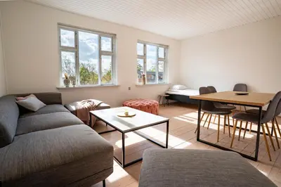 a living room with a couch and a table at Holstebro Apartments in Holstebro