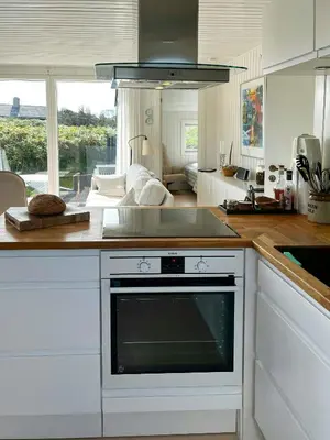 a kitchen with a sink and a stove top oven at Family House Close To The Sea At Tranum Strand in Brovst