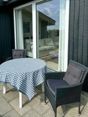 a table and two chairs on a patio at Family House Close To The Sea At Tranum Strand in Brovst