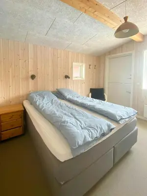 a large bed in a bedroom with a ceiling at Holiday Home With Pool And Fjord Views On Lundø in Højslev