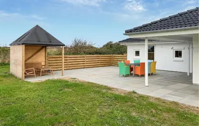 a patio with a gazebo and a table and chairs at Cozy Home In Struer With Sauna in Struer
