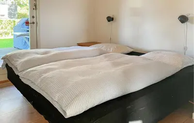 two beds sitting next to each other in a room at 3 Bedroom Gorgeous Home In Hurup Thy in Doverodde