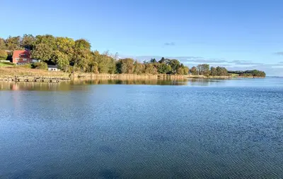 a large body of water with a house in the distance at 3 Bedroom Gorgeous Home In Hurup Thy in Doverodde