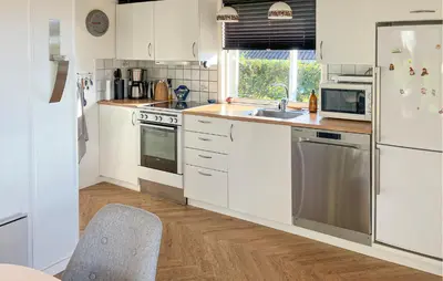 a white kitchen with a sink and a refrigerator at 3 Bedroom Gorgeous Home In Hurup Thy in Doverodde