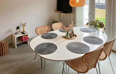 a dining room with a white table and chairs at Pet Friendly Home In Vestervig With Sauna in Vestervig