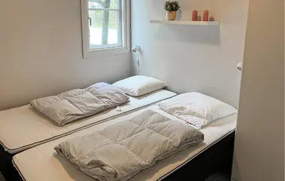 two beds sitting next to each other in a room at Pet Friendly Home In Vestervig With Sauna in Vestervig