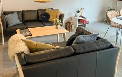 a black leather couch in a living room at Pet Friendly Home In Vestervig With Sauna in Vestervig