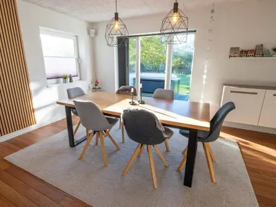 a dining room with a wooden table and chairs at 4 star holiday home in Hanstholm in Hanstholm