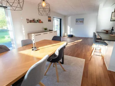 a kitchen and dining room with a wooden table and chairs at 4 star holiday home in Hanstholm in Hanstholm