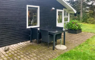 a table and chairs on a patio outside of a house at 3 Bedroom Awesome Home In Højslev in Højslev