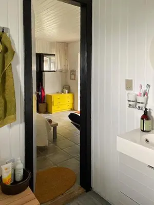 a hallway with a sink and a room with a kitchen at Summerhouse By The Heath Near The North Sea in Snedsted