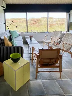 a living room with a couch and chairs at Summerhouse By The Heath Near The North Sea in Snedsted
