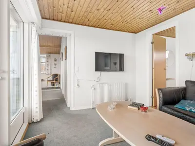 a living room with a table and a couch at Holiday Home Gisa - 500m from the sea by Interhome in Thisted