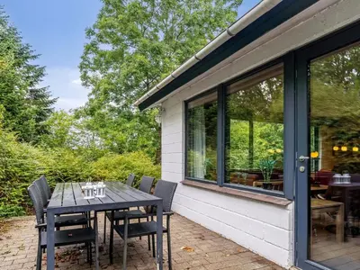 a table and chairs on the patio of a house at Holiday Home Velika - 300m to the fjord by Interhome in Roslev