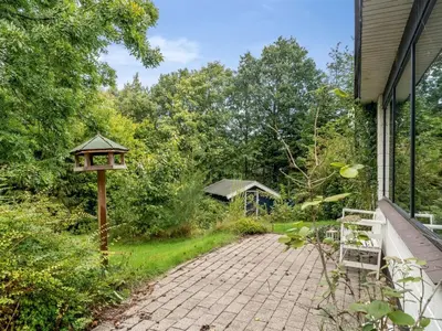 a brick driveway with a bird house on the side of a house at Holiday Home Velika - 300m to the fjord by Interhome in Roslev