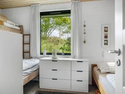 a bedroom with two beds and a window at Holiday Home Velika - 300m to the fjord by Interhome in Roslev