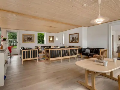 a living room with a table and chairs at Holiday Home Nette - 2km to the fjord by Interhome in Thyholm
