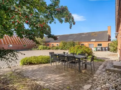 a table and chairs in front of a building at Holiday Home Nette - 2km to the fjord by Interhome in Thyholm