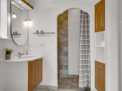 a bathroom with a sink and a shower at Holiday Home Nette - 2km to the fjord by Interhome in Thyholm