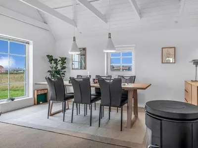 a dining room with a table and chairs at Holiday Home Amber - 300m from the sea by Interhome in Harboør